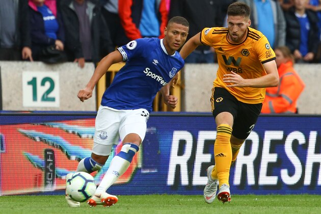 Everton's Brazilian striker Richarlison (L) plays the ball during the English Premier League football match between Wolverhampton Wanderers and Everton at the Molineux stadium in Wolverhampton, central England on August 11, 2018. (Photo by Geoff CADDICK / AFP) / RESTRICTED TO EDITORIAL USE. No use with unauthorized audio, video, data, fixture lists, club/league logos or 'live' services. Online in-match use limited to 120 images. An additional 40 images may be used in extra time. No video emulation. Social media in-match use limited to 120 images. An additional 40 images may be used in extra time. No use in betting publications, games or single club/league/player publications. /         (Photo credit should read GEOFF CADDICK/AFP/Getty Images)