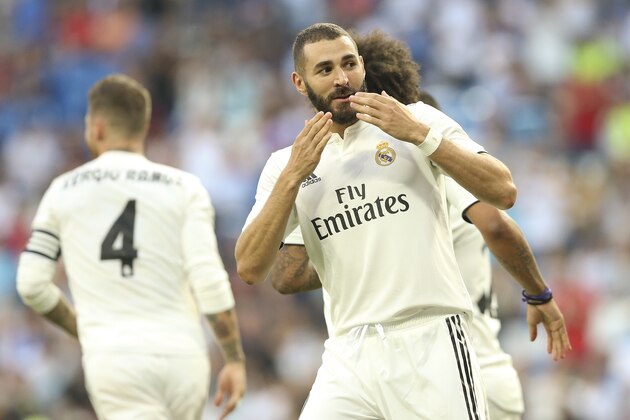 Real Madrid's Karim Benzema, right, celebrates after scoring their side's first goal against AC Milan during the Santiago Bernabeu trophy soccer match between Real Madrid and AC Milan at the Santiago Bernabeu stadium, in Madrid, Saturday, Aug. 11, 2018. (AP Photo/Andrea Comas)