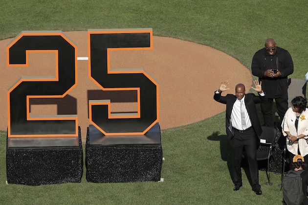 Former San Francisco Giants player Barry Bonds waves to fans next to his mother, Pat, as he is honored during a ceremony to retire his jersey number before a baseball game between the Giants and the Pittsburgh Pirates in San Francisco, Saturday, Aug. 11, 2018. (AP Photo/Jeff Chiu, Pool)