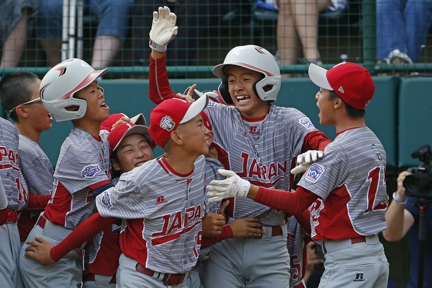 Japan's Seiya Arai, second from right, celebrates scoring the game-winning run on a single by Natsuki Yajima off Lufkin, Texas' Malcolm Deason in the fifth inning of the Little League World Series Championship baseball game in South Williamsport, Pa., Sunday, Aug. 27, 2017. Japan won 12-2 in five innings. (AP Photo/Gene J. Puskar).