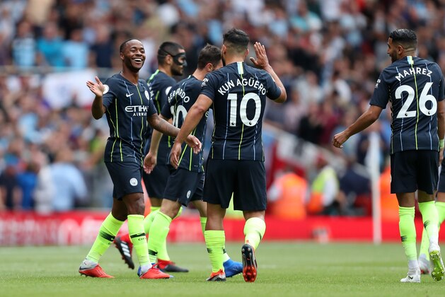 LONDON, ENGLAND - AUGUST 12: Raheem Sterling of Manchester City celebrates with his team mates after scoring a goal to make it 0-1 during the Premier League match between Arsenal FC and Manchester City at Emirates Stadium on August 12, 2018 in London, United Kingdom. (Photo by James Baylis - AMA/Getty Images)