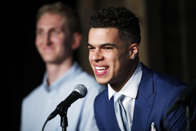 FILE - In this June 22, 2018, file photo, Michael Porter Jr., the Denver Nuggets first-round pick in the NBA Draft, jokes with reporters as one of the team's two, second-round selections, Thomas Welsh, looks on during a news conference to introduce the players to the media, in Denver. Nuggets rookie forward Michael Porter Jr. has undergone back surgery in Dallas and there is no timetable for his return to the court. The team said Thursday, July 19, 2018, the procedure of the lumbar spine was performed by Dr. Andrew Dossett at the Carrell Clinic. (AP Photo/David Zalubowski, File)