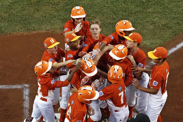 Lufkin, Texas' Collin Ross, center, is greeted by teammates after hitting a three-run home run off Fairfield, Conn., pitcher Matthew Vivona in the first inning of a Little League World Series baseball game in South Williamsport, Pa., Thursday, Aug. 24, 2017. Texas won 14-4. (AP Photo/Gene J. Puskar)
