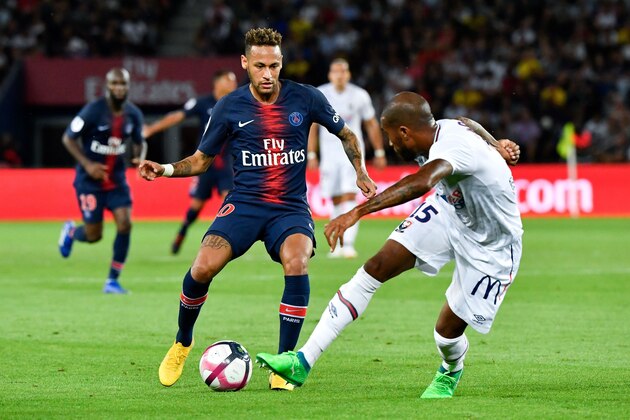 Paris Saint-Germain's Brazilian forward Neymar (L) vies for the ball with Caen's Beninese defender Emmanuel Imorou during the French L1 football match between Paris Saint-Germain and Caen on August 12, 2018 at the Parc des Princes, in Paris. (Photo by GERARD JULIEN / AFP)        (Photo credit should read GERARD JULIEN/AFP/Getty Images)