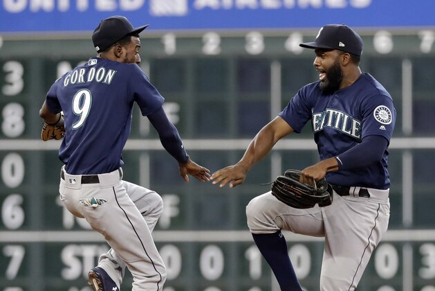 Seattle Mariners' Dee Gordon (9) and Denard Span celebrate after a baseball game against the Houston Astros Sunday, Aug. 12, 2018, in Houston. The Mariners won 4-3 in 10 innings. (AP Photo/David J. Phillip)