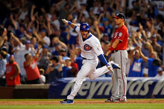 CHICAGO, IL - AUGUST 12: David Bote #13 of the Chicago Cubs celebrates his walk-off grand slam as Ryan Zimmerman #11 of the Washington Nationals looks on at Wrigley Field on August 12, 2018 in Chicago, Illinois. The Chicago Cubs won 4-3. (Photo by Jon Durr/Getty Images)