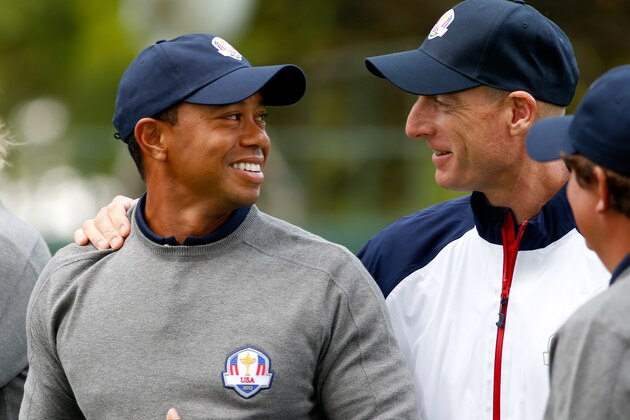 MEDINAH, IL - SEPTEMBER 25:  Tiger Woods talks with Jim Furyk during the USA team photocall during the second preview day of The 39th Ryder Cup at Medinah Country Golf Club on September 25, 2012 in Medinah, Illinois.  (Photo by Jamie Squire/Getty Images)