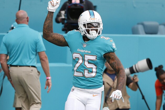 Miami Dolphins cornerback Xavien Howard (25) raises his fist after scoring a touchdown, during the first half of an NFL football game against the Denver Broncos, Sunday, Dec. 3, 2017, in Miami Gardens, Fla. (AP Photo/Wilfredo Lee)