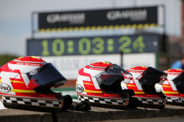 DOUGLAS, ISLE OF MAN - JUNE 08:  Helmets line the pit wall before the superbike TT race in Douglas on June 8, 2009, Isle Of Man, United Kingdom. The annual TT race is one of the highlights of the motorbike racing calender with fans travelling from around the globe to watch riders compete in the 37 and three quarter mile lap exceeding speeds of 200mph.  (Photo by Dan Kitwood/Getty Images)