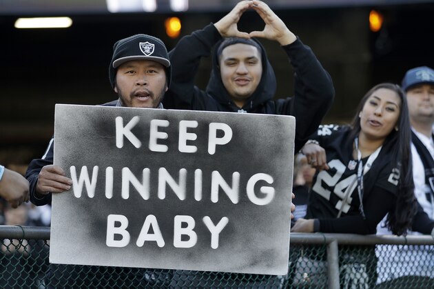 Oakland Raiders fans cheer before an NFL football game between the Oakland Raiders and the Indianapolis Colts in Oakland, Calif., Saturday, Dec. 24, 2016. (AP Photo/Marcio Jose Sanchez)
