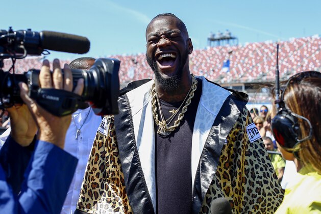 WBC Heavyweight Champion Deontay Wilder cuts up in an interview before the GEICO 500 NASCAR Talladega auto race at Talladega Superspeedway, Sunday, April 29, 2018, in Talladega, Ala. (AP Photo/Butch Dill)