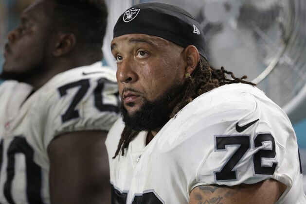 Oakland Raiders offensive tackle Donald Penn (72) sits on the sidelines, during the first half of an NFL football game against the Miami Dolphins, Sunday, Nov. 5, 2017, in Miami Gardens, Fla. (AP Photo/Lynne Sladky)