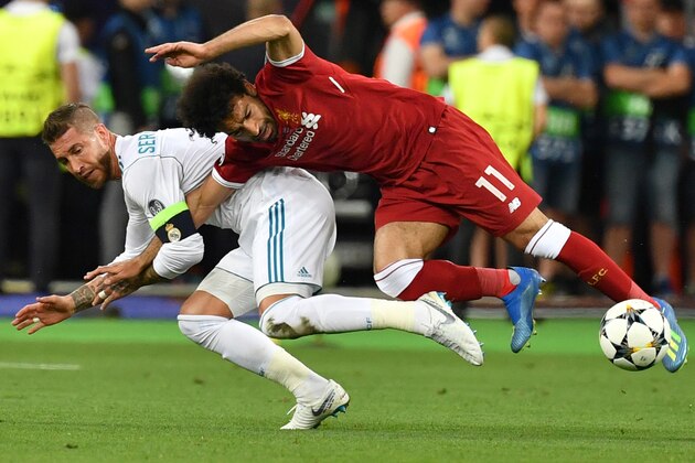 TOPSHOT - Liverpool's Egyptian forward Mohamed Salah (R) falls with Real Madrid's Spanish defender Sergio Ramos leading to Salah being injured during the UEFA Champions League final football match between Liverpool and Real Madrid at the Olympic Stadium in Kiev, Ukraine, on May 26, 2018. (Photo by GENYA SAVILOV / AFP)        (Photo credit should read GENYA SAVILOV/AFP/Getty Images)