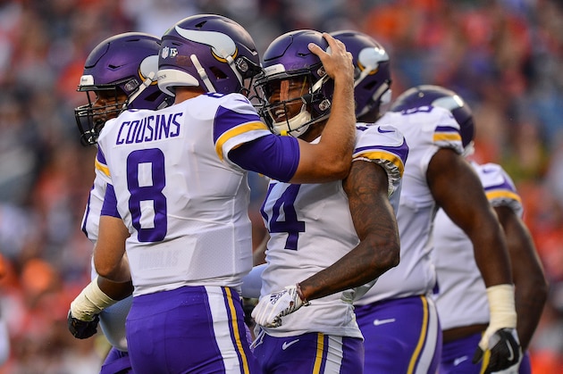 DENVER, CO - AUGUST 11:  Quarterback Kirk Cousins #8 of the Minnesota Vikings celebrates after a first quarter touchdown pass to wide receiver Stefon Diggs #14 against the Denver Broncos during an NFL preseason game at Broncos Stadium at Mile High on August 11, 2018 in Denver, Colorado. (Photo by Dustin Bradford/Getty Images)