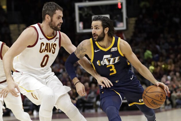 Utah Jazz's Ricky Rubio (3), from Spain, drives past Cleveland Cavaliers' Kevin Love (0) in the first half of an NBA basketball game, Saturday, Dec. 16, 2017, in Cleveland. (AP Photo/Tony Dejak)