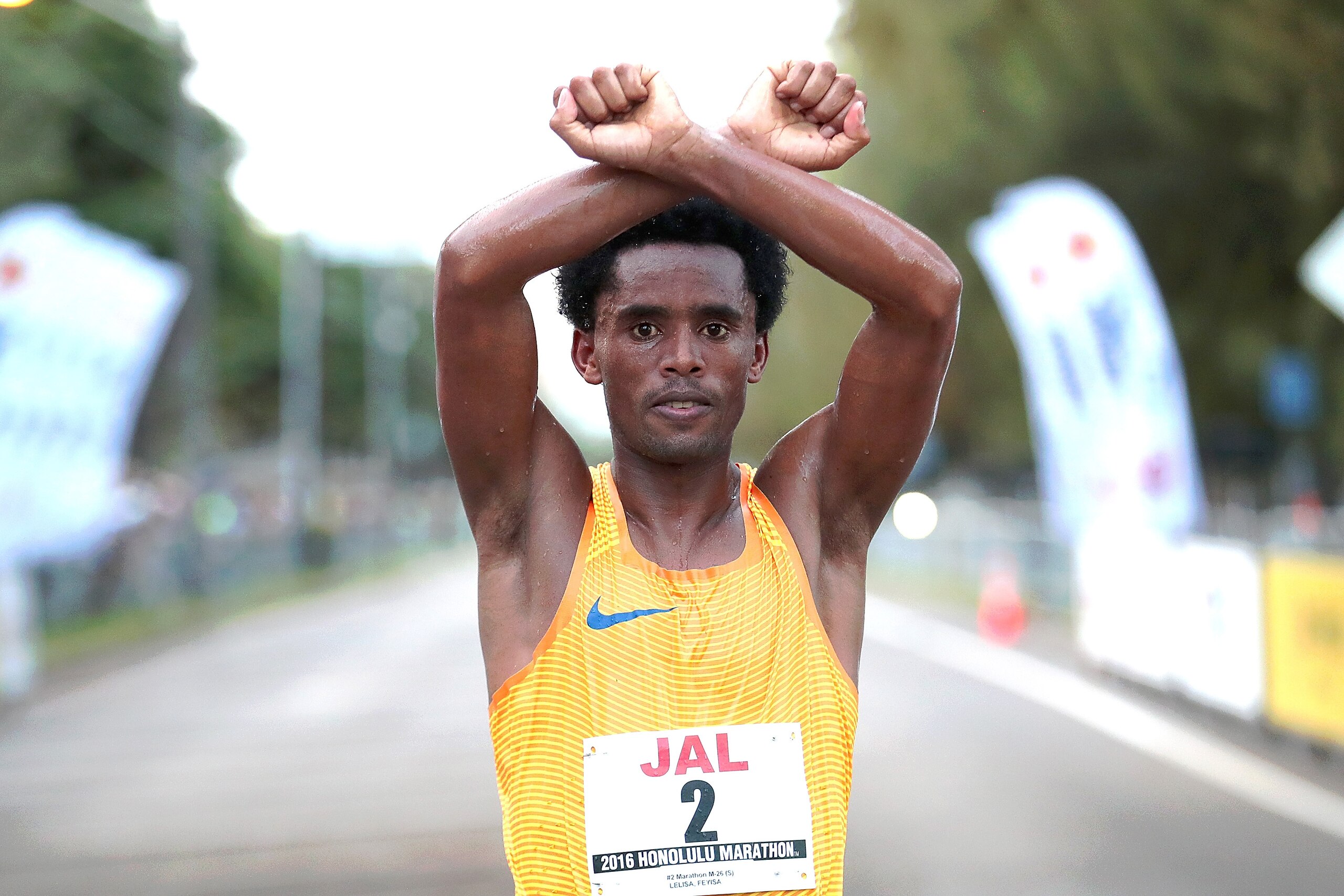 HONOLULU, HI - DECEMBER 11:  Feyisa Lilesa of Ethiopia poses for a photograph after crossing the finish line during the Honolulu Marathon 2016 on December 11, 2016 in Honolulu, Hawaii.  (Photo by Tom Pennington/Getty Images for HONOLULU MARATHON)