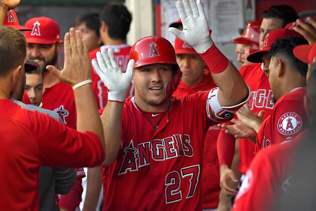 ANAHEIM, CA - JULY 25:  Mike Trout #27 of the Los Angeles Angels of Anaheim gets high fives in the dugout after a solo home run in the first inning off James Shields #33 of the Chicago White Sox at Angel Stadium on July 25, 2018 in Anaheim, California.  (Photo by Jayne Kamin-Oncea/Getty Images)