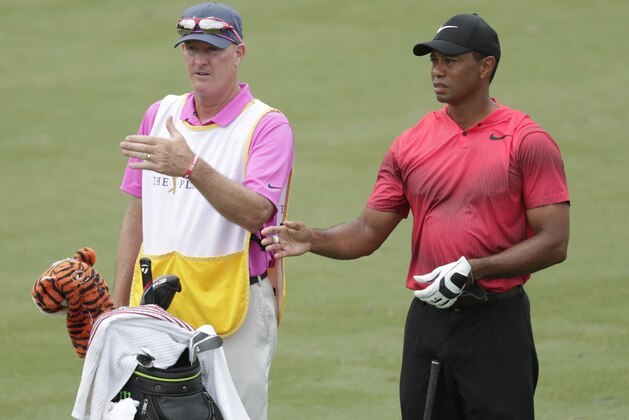 Tiger Woods and his caddie Joe Lacava, look down the third fairway, during the final round of The Players Championship golf tournament, Sunday, May 13, 2018, in Ponte Vedra Beach, Fla. (AP Photo/Lynne Sladky)