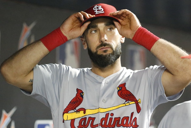 St. Louis Cardinals first baseman Matt Carpenter puts on his cap during the fifth inning of a baseball game against the Miami Marlins, Monday, Aug. 6, 2018, in Miami. The Marlins defeated the Cardinals 2-1. (AP Photo/Wilfredo Lee)