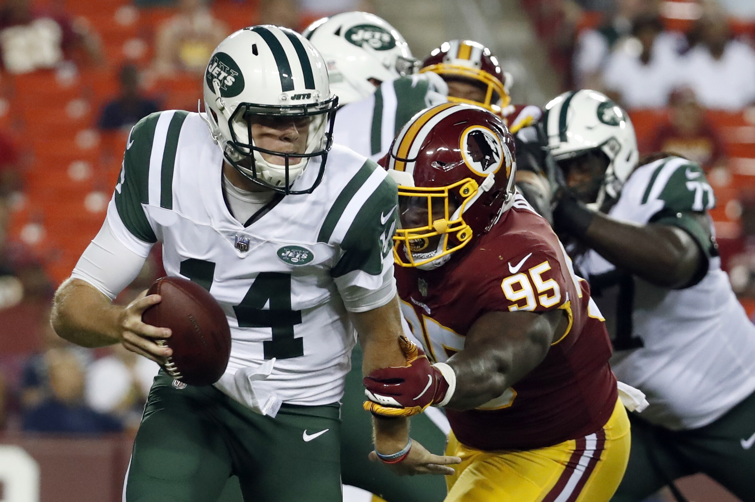 New York Jets quarterback Sam Darnold (14) is sacked by Washington Redskins defensive tackle Da'Ron Payne (95) during the first half of a preseason NFL football game Thursday, Aug. 16, 2018, in Landover, Md. (AP Photo/Alex Brandon)