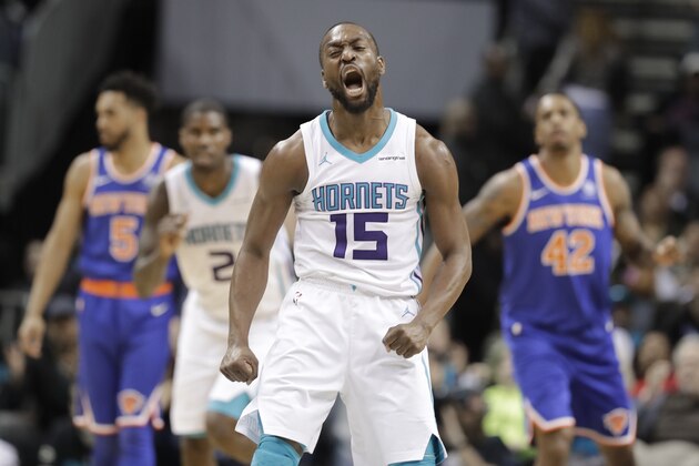 Charlotte Hornets' Kemba Walker (15) reacts to making a 3-point basket against the New York Knicks during overtime of an NBA basketball game in Charlotte, N.C., Monday, March 26, 2018. (AP Photo/Chuck Burton)