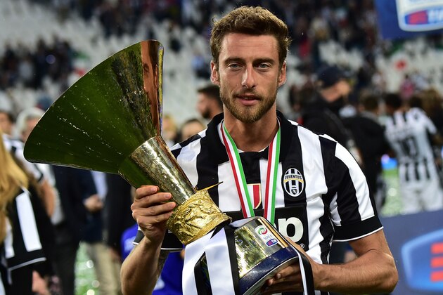 Juventus' midfielder Claudio Marchisio poses with the Italian League's trophy during a ceremony following the Italian Serie A football match Juventus vs Napoli on May 23, 2015 at the Juventus stadium in Turin. Juventus won the Coppa Italia on May 20, 2015 and the Italian League today after their 3-1 victory over Napoli.     AFP PHOTO / GIUSEPPE CACACE        (Photo credit should read GIUSEPPE CACACE/AFP/Getty Images)