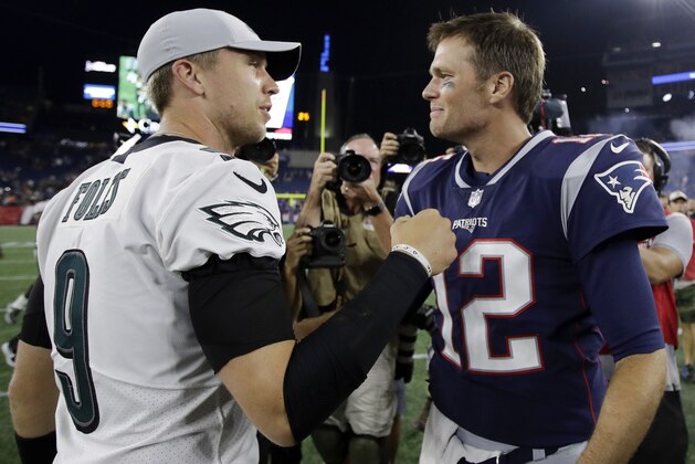Philadelphia Eagles quarterback Nick Foles (9) and New England Patriots quarterback Tom Brady (12) speak at midfield after a preseason NFL football game, Thursday, Aug. 16, 2018, in Foxborough, Mass. (AP Photo/Charles Krupa)