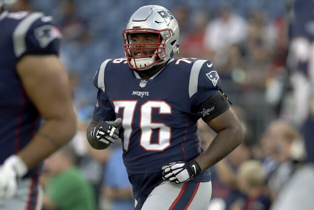 New England Patriots offensive lineman Isaiah Wynn limbers up before a preseason NFL football game against the Washington Redskins, Thursday, Aug. 9, 2018, in Foxborough, Mass. (AP Photo/Charles Krupa)