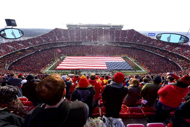 KANSAS CITY, MO - JANUARY 6: Fans stand at attention for the national anthem overlooking a 100 yard American flag prior the AFC Wild Card Playoff Game between the Kansas City Chiefs and the Tennessee Titans at Arrowhead Stadium on January 6, 2018 in Kansas City, Missouri. (Photo by Jason Hanna/Getty Images)