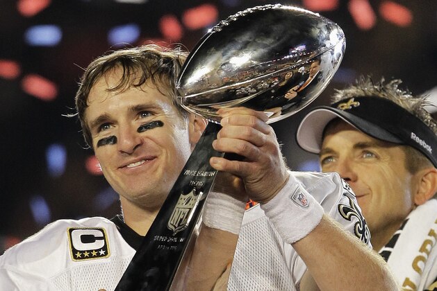 New Orleans Saints quarterback Drew Brees (9) celebrates with the Vince Lombardi Trophy after the Saints' 31-17 win over the Indianapolis Colts in the NFL Super Bowl XLIV football game in Miami, Sunday, Feb. 7, 2010. (AP Photo/Julie Jacobson)