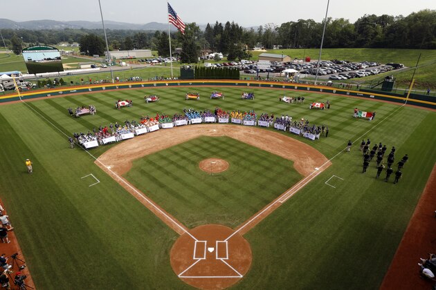 The 16 Little League teams competing in the 2018 Little League World Series baseball tournament line the field at Volunteer Stadium during the opening ceremony in South Williamsport, Pa., Thursday, Aug. 16, 2018. (AP Photo/Gene J. Puskar)