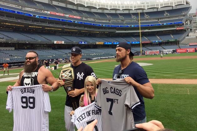 New York Yankees' Aaron Judge, second from left, poses for a photo with wrestlers William Morrissey, know as