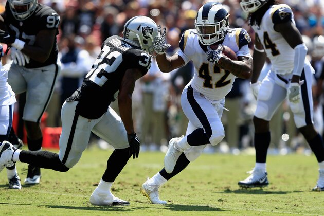 LOS ANGELES, CA - AUGUST 18:  John Kelly #42 of the Los Angeles Rams eludes Antonio Hamilton #32 of the Oakland Raiders  during the first  half of a preseason game at Los Angeles Memorial Coliseum on August 18, 2018 in Los Angeles, California.  (Photo by Sean M. Haffey/Getty Images)