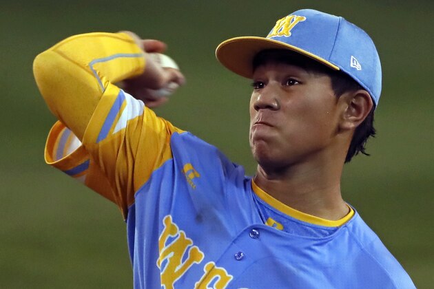Honolulu's Aukai Kea delivers in the third inning of a baseball game against Peachtree City, Ga., in the Little League World Series in South Williamsport, Pa., Friday, Aug. 17, 2018. Hawaii won 2-0 with a walk-off, two-run home run by Kea in the 11th inning. (AP Photo/Gene J. Puskar)