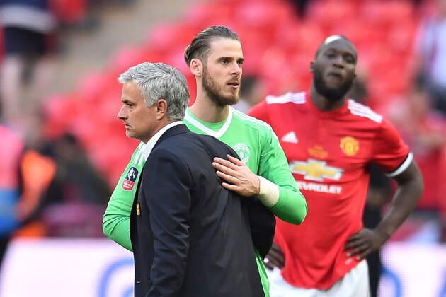 Manchester United's Portuguese manager Jose Mourinho (L) reacts with Manchester United's Spanish goalkeeper David de Gea (C) after losing the English FA Cup final football match between Chelsea and Manchester United at Wembley stadium in London on May 19, 2018. (Photo by Glyn KIRK / AFP) / NOT FOR MARKETING OR ADVERTISING USE / RESTRICTED TO EDITORIAL USE        (Photo credit should read GLYN KIRK/AFP/Getty Images)