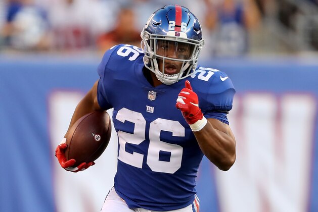 EAST RUTHERFORD, NJ - AUGUST 09:  Saquon Barkley #26 of the New York Giants carries the bal in the first quarter against the Cleveland Browns during their preseason game on August 9,2018 at MetLife Stadium in East Rutherford, New Jersey.  (Photo by Elsa/Getty Images)