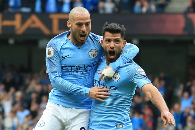 Manchester City's Argentinian striker Sergio Aguero (R) celebrates scoring the opening goal with Manchester City's Spanish midfielder David Silva (L) during the English Premier League football match between Manchester City and Huddersfield Town at the Etihad Stadium in Manchester, north west England, on August 19, 2018. (Photo by Lindsey PARNABY / AFP) / RESTRICTED TO EDITORIAL USE. No use with unauthorized audio, video, data, fixture lists, club/league logos or 'live' services. Online in-match use limited to 120 images. An additional 40 images may be used in extra time. No video emulation. Social media in-match use limited to 120 images. An additional 40 images may be used in extra time. No use in betting publications, games or single club/league/player publications. /         (Photo credit should read LINDSEY PARNABY/AFP/Getty Images)