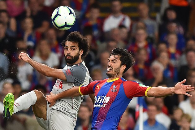 Liverpool's Egyptian midfielder Mohamed Salah (L) vies with Crystal Palace's English defender James Tomkins (R) during the English Premier League football match between Crystal Palace and Liverpool at Selhurst Park in south London on August 20, 2018. (Photo by Glyn KIRK / AFP) / RESTRICTED TO EDITORIAL USE. No use with unauthorized audio, video, data, fixture lists, club/league logos or 'live' services. Online in-match use limited to 120 images. An additional 40 images may be used in extra time. No video emulation. Social media in-match use limited to 120 images. An additional 40 images may be used in extra time. No use in betting publications, games or single club/league/player publications. /         (Photo credit should read GLYN KIRK/AFP/Getty Images)