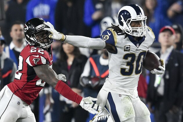 Los Angeles Rams running back Todd Gurley, right, pushes off Atlanta Falcons strong safety Keanu Neal during the first half of an NFL football wild-card playoff game Saturday, Jan. 6, 2018, in Los Angeles. (AP Photo/Kelvin Kuo)