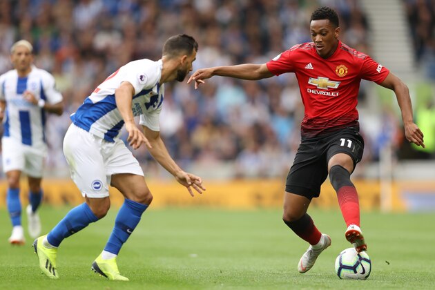 BRIGHTON, ENGLAND - AUGUST 19:  Martin Montoya of Brighton and Hove Albion and Anthony Martial of Manchester United battle for the ball during the Premier League match between Brighton & Hove Albion and Manchester United at American Express Community Stadium on August 19, 2018 in Brighton, United Kingdom.  (Photo by Dan Istitene/Getty Images)