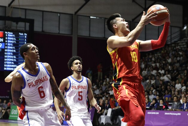 China's Rui Zhao, right, shoots for a basket as Philippines' Jordan Clarkson, left, and Gabriel Norwood watch during their men's basketball game at the 18th Asian Games in Jakarta, Indonesia on Tuesday, Aug. 21, 2018. (AP Photo/Aaron Favila) China's Rui Zhao, right, shoots for a basket as Philippines' Jordan Clarkson, left, and Gabriel Norwood watch during their men's basketball game at the 18th Asian Games in Jakarta, Indonesia on Tuesday, Aug. 21, 2018. (AP Photo/Aaron Favila)