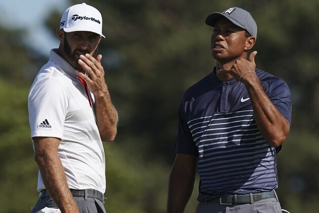 Tiger Woods, right, motions to call over an official after the wind moved his ball on the tenth green after he had already addressed it during the first round of the U.S. Open Golf Championship, Thursday, June 14, 2018, in Southampton, N.Y. Dustin Johnson looked on. (AP Photo/Carolyn Kaster)