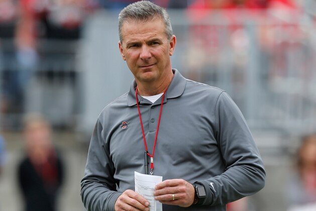 FILE - In this April 14, 2018, file photo, Ohio State coach Urban Meyer watches the NCAA college football team's spring game in Columbus, Ohio. Ohio State has placed Meyer on paid administrative leave while it investigates claims that his wife knew about allegations of abuse against an assistant coach years before he was fired last week. (AP Photo/Jay LaPrete, File)