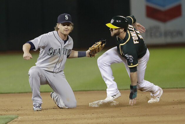 Seattle Mariners second baseman Gordon Beckham, left, tags out Oakland Athletics' Dustin Fowler trying to steal second during the eighth inning of a baseball game in Oakland, Calif., Wednesday, May 23, 2018. (AP Photo/Jeff Chiu)