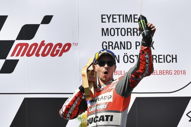 Spain's rider Jorge Lorenzo of the Ducati Team celebrates on the podium after winning the MotoGP race at the Austrian motorcycle Grand Prix at the Red Bull Ring in Spielberg, Austria, Sunday, Aug. 12, 2018. (AP Photo/Kerstin Joensson)