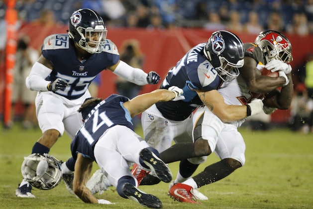 Tennessee Titans wide receiver Nick Williams (14) loses his helmet as he tries to bring down Tampa Bay Buccaneers running back Shaun Wilson, right, in the second half of a preseason NFL football game Saturday, Aug. 18, 2018, in Nashville, Tenn. (AP Photo/James Kenney)