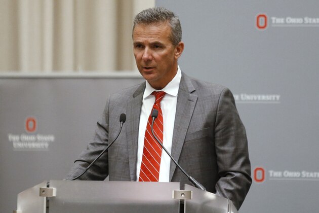 Ohio State football coach Urban Meyer makes a statement during a news conference in Columbus, Ohio, Wednesday, Aug. 22, 2018. Ohio State suspended Meyer on Wednesday for three games for mishandling domestic violence accusations, punishing one of the sport's most prominent leaders for keeping an assistant on staff for several years after the coach's wife accused him of abuse. Athletic director Gene Smith was suspended from Aug. 31 through Sept. 16. (AP Photo/Paul Vernon)
