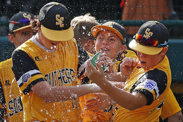 Peachtree City, Georgia pitcher Jansen Kenty left, and James Hopper, right, get a shower from Will Clem after getting the final out of a 4-3 complete-game win over Grosse Pointe Woods, Michigan in an elimination baseball game in United States pool play at the Little League World Series tournament in South Williamsport, Pa., Wednesday, Aug. 22, 2018. Georgia's win eliminates Michigan. (AP Photo/Gene J. Puskar) Peachtree City, Georgia pitcher Jansen Kenty left, and James Hopper, right, get a shower from Will Clem after getting the final out of a 4-3 complete-game win over Grosse Pointe Woods, Michigan in an elimination baseball game in United States pool play at the Little League World Series tournament in South Williamsport, Pa., Wednesday, Aug. 22, 2018. Georgia's win eliminates Michigan. (AP Photo/Gene J. Puskar)