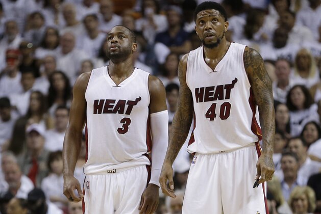 Miami Heat forward Udonis Haslem (40) and guard Dwyane Wade (3) look up during the second half of Game 3 of an NBA second-round playoff basketball series against the Toronto Raptors, Saturday, May 7, 2016, in Miami. (AP Photo/Alan Diaz)