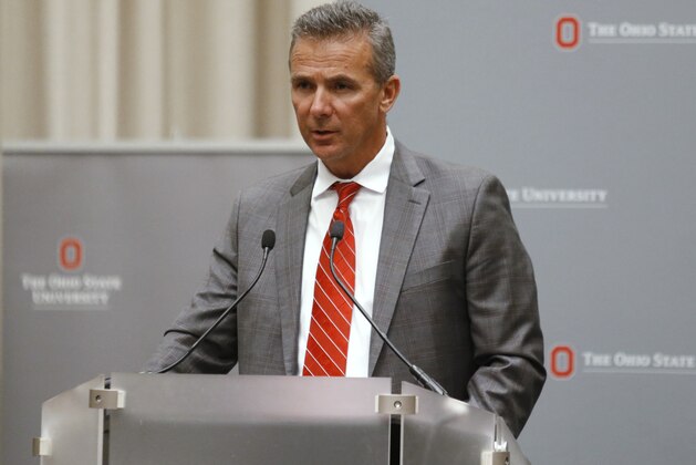 Ohio State football coach Urban Meyer makes a statement during a news conference in Columbus, Ohio, Wednesday, Aug. 22, 2018. Ohio State suspended Meyer on Wednesday for three games for mishandling domestic violence accusations, punishing one of the sport's most prominent leaders for keeping an assistant on staff for several years after the coach's wife accused him of abuse. Athletic director Gene Smith was suspended from Aug. 31 through Sept. 16. (AP Photo/Paul Vernon)
